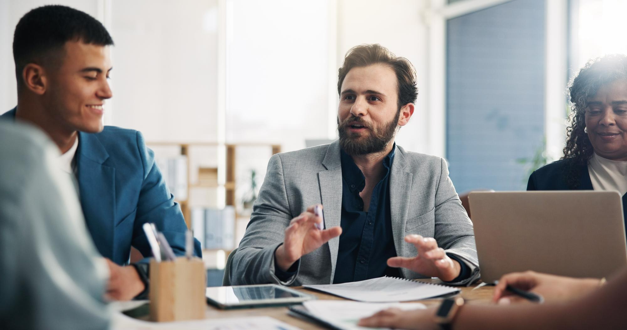 Colleagues in discussion at a meeting table