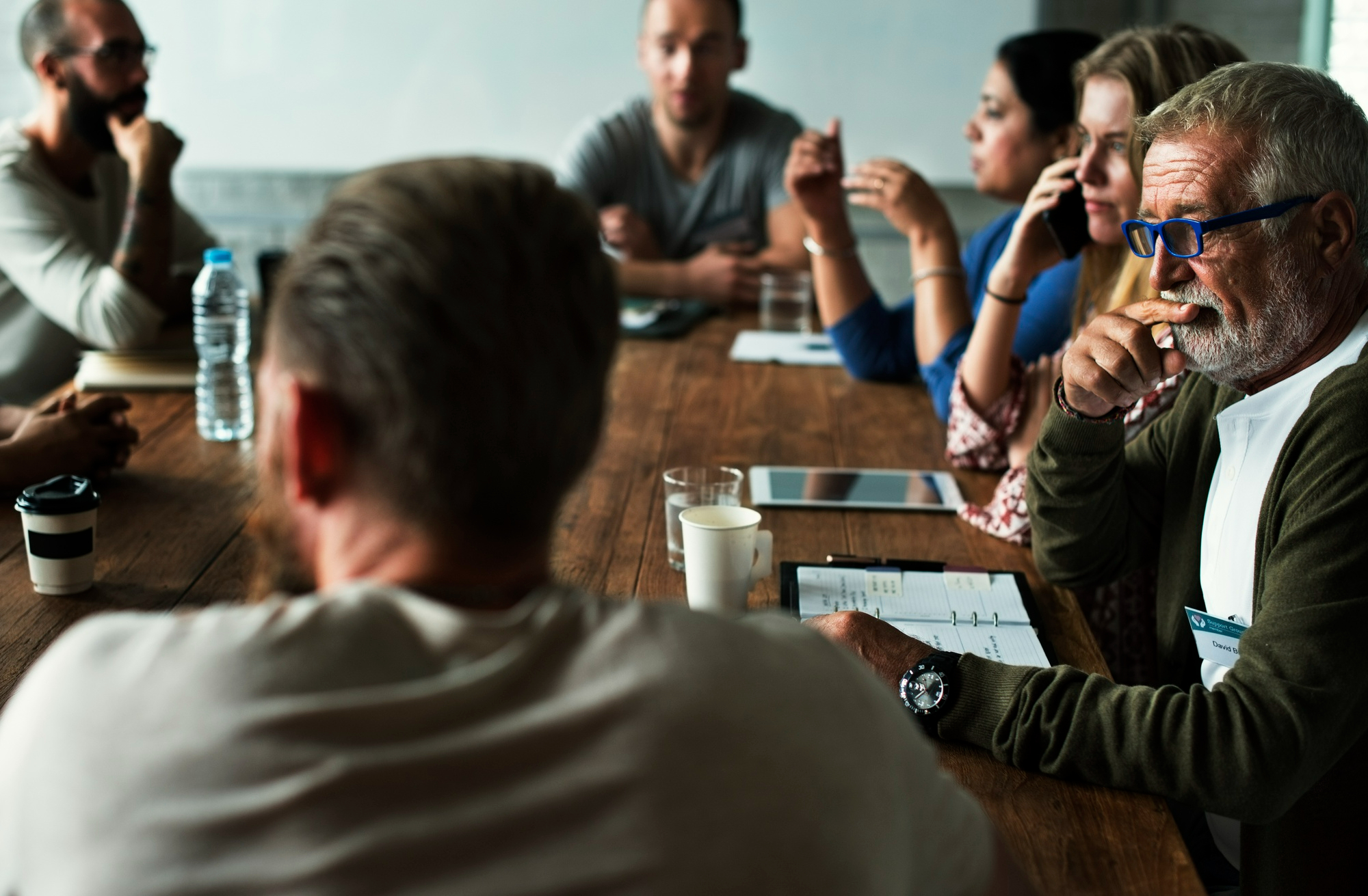 Colleagues in a group meeting around a table