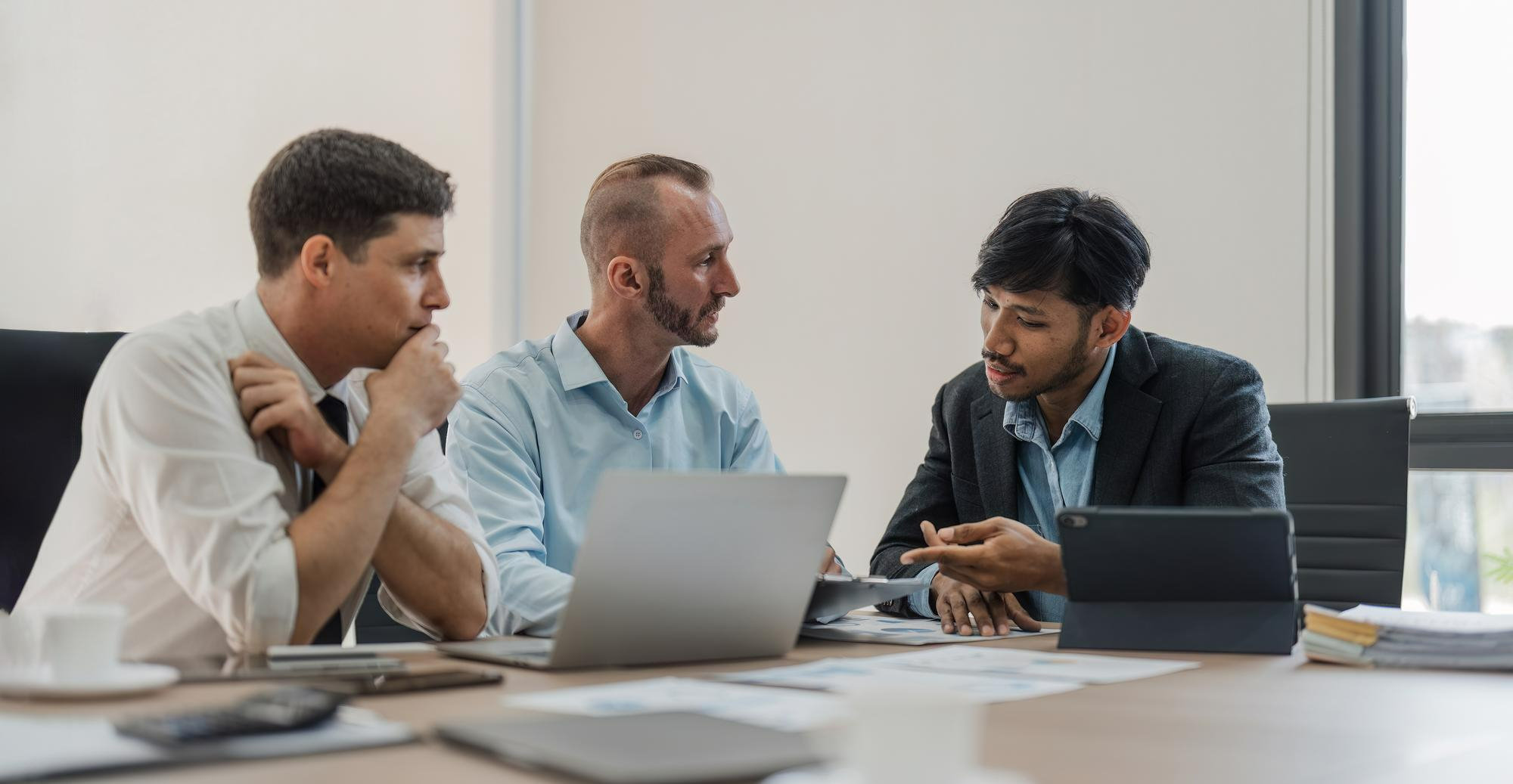 Colleagues in discussion in a bright office