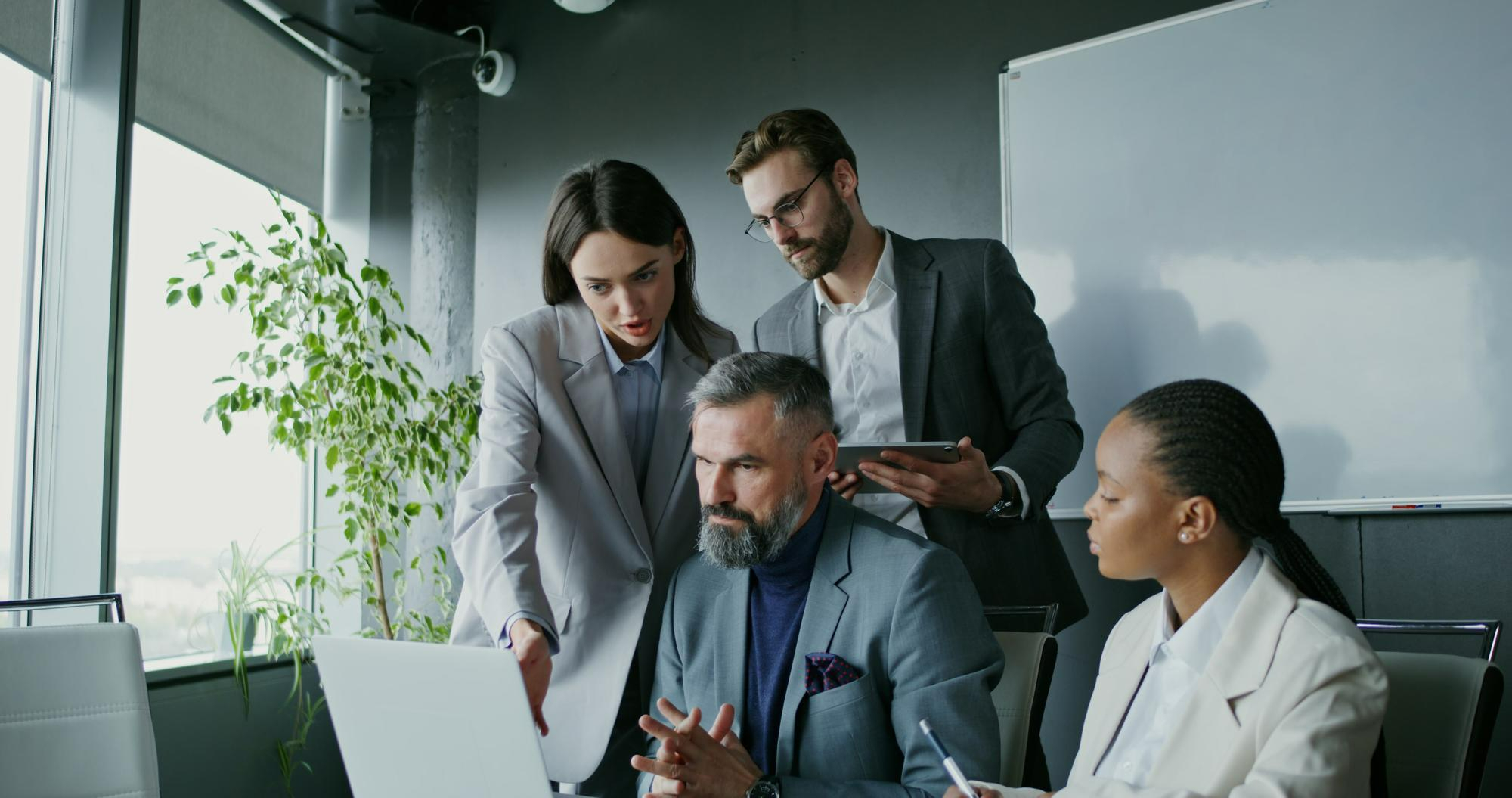 Colleagues reviewing work together in a modern office
